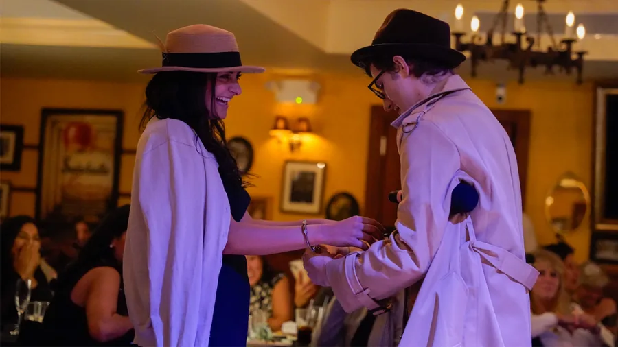 A Murder Mystery Company detective questioning a guest at a Philadelphia show